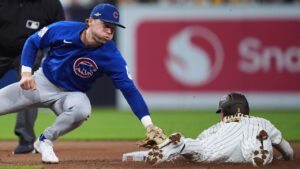Chicago Cubs second baseman Nico Hoerner tries to tag San Diego Padres Jackson Merrill as he steal second base in the second inning of Game 2 of the National League Wild Card baseball playoff series Wednesday, Sept. 30, 2026, in San Diego. (Gregory Bull/AP)
