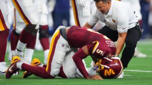 Washington Commanders quarterback Jayden Daniels (5) reacts after an apparent injury in the first half against the Dallas Cowboys during an NFL football game in Arlington, Texas, Sunday, Sept. 20, 2026. (Julio Cortez/AP)