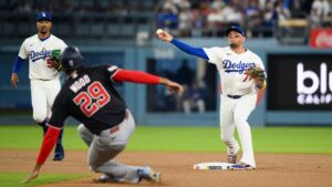 Los Angeles Dodgers second baseman Miguel Rojas (72) turns a double play over the slide by Washington Nationals' James Wood during the first inning of a baseball game in Los Angeles, Sunday, Sept. 6, 2026. (Kyusung Gong/AP)