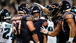 Chicago Bears centre Garrett Bradbury, Case Keenum, centre, and others celebrate after Keenum carried the ball for a touchdown during the second half of an NFL football game against the Philadelphia Eagles in Chicago, Monday, Sept. 28, 2026. (Nam Y. Huh/AP)