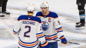 Edmonton Oilers center Connor McDavid (97) speaks with teammate defenseman Evan Bouchard (2) during the third period of an NHL hockey game against the Utah Mammoth, Tuesday, April 7, 2026, in Salt Lake City. (Melissa Majchrzak/AP)