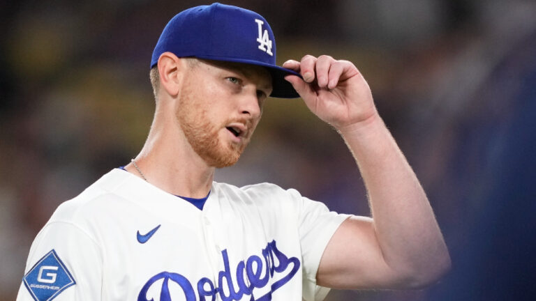 Los Angeles Dodgers starting pitcher Eric Lauer adjusts his cap while the crowd applauds as he walks off the field after being relieved during the seventh inning of a baseball game against the Kansas City Royals, Wednesday, Aug. 12, 2026, in Los Angeles. (Mark J. Terrill/AP)