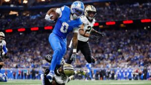 Detroit Lions running back Jahmyr Gibbs carries against New Orleans Saints safety Julian Blackmon and Justin Reid in the first half of an NFL game, Sunday, Sept. 13, 2026, in Detroit. (AP/Rey Del Rio)