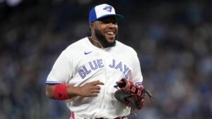 Toronto Blue Jays first baseman Vladimir Guerrero Jr. (27) smiles while running back to the dugout after the inning during third inning MLB baseball action in Toronto on Friday, March 27, 2026. (Nathan Denette/CP)