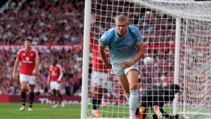 Manchester City's Erling Haaland celebrates after scoring his sides first goal during the English Premier League soccer match against Manchester United in Manchester, England, Sunday Sept. 13, 2026. (Peter Byrne/PA via AP)