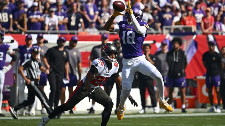 Minnesota Vikings wide receiver Justin Jefferson (18) catches a pass for a first down as Tampa Bay Buccaneers cornerback Jacob Parrish (25) defends during the first half of an NFL football game in Tampa, Fla., Sunday, Sept. 27, 2026. (AP Photo/Jason Behnken)