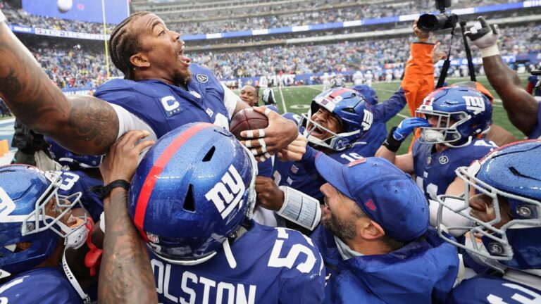 New York Giants safety Jevon Holland, top, celebrates his interception with teammates late in the second half of an NFL game against the Tennessee Titans in East Rutherford, N.J., Sunday, Sept. 27, 2026. (AP/Adam Hunger)