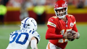 Kansas City Chiefs quarterback Patrick Mahomes (15) runs for a first down as Indianapolis Colts safety Hunter Wohler (30) defends during overtime of an NFL football game Sunday, Sept. 20, 2026, in Kansas City, Mo. (AP Photo/Colin E. Braley)