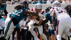 New England Patriots quarterback Drake Maye runs against Jacksonville Jaguars defensive tackle Davon Hamilton in the first half during an NFL game in Jacksonville, Fla., Sunday, Sept. 27, 2026. (AP/Mike Stewart)