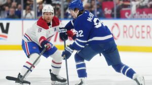 Toronto Maple Leafs' Gavin McKenna (92) looks to pass as Montreal Canadiens' Mike Matheson (8) defends during first period NHL hockey action in Toronto on Tuesday, Sept. 29, 2026. (Nathan Denette/CP)