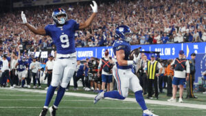 New York Giants running back Cam Skattebo, right, with teammate Isaiah Likely (9) celebrating, scores a touchdown against the Dallas Cowboys during the first half of an NFL football game Sunday, Sept. 13, 2026, in East Rutherford, N.J. (Pamela Smith/AP)