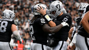 Las Vegas Raiders running back Ashton Jeanty (2) celebrates with teammate quarterback Kirk Cousins (8) after catching a touchdown pass during the first half of an NFL football game against the Miami Dolphins, Sunday, Sept. 13, 2026, in Las Vegas. (David Becker/AP)