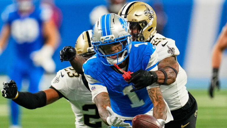 Detroit Lions wide receiver Jameson Williams (1) can't hold into a pass as he is defended by New Orleans Saints safety Justin Reid (21) and safety Julian Blackmon (23) in the first half of an NFL football game, Sunday, Sept. 13, 2026, in Detroit. (Paul Sancya/AP)