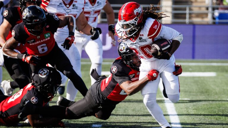 Calgary Stampeders running back Deonta McMahon (20) is tackled by Ottawa Redblacks defensive back Alonzo Addae (20) during first half CFL action in Ottawa, on Saturday, Sept. 26, 2026. (Keito Newman/CP)