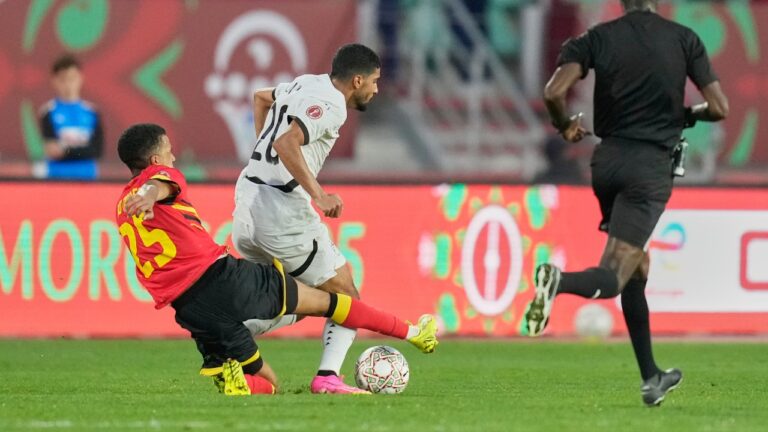 Angola's Rui Modesto, left, challenges Egypt's Ibrahim Adel during the Africa Cup of Nations group B soccer match between Angola and Egypt in Agadir, Morocco, Monday, Dec. 29, 2025. (AP Photo/Mosa'ab Elshamy)