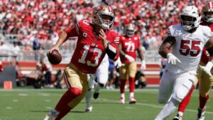 San Francisco 49ers quarterback Brock Purdy (13) runs against Arizona Cardinals defensive tackle Dante Stills (55) during the first half of an NFL football game in Santa Clara, Calif., Sunday, Sept. 27, 2026. (Kelley L. Cox/AP)