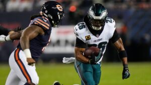 Philadelphia Eagles running back Saquon Barkley (26) runs the ball as Chicago Bears linebacker Devin Bush, left, defends during the first half of an NFL football game in Chicago, Monday, Sept. 28, 2026. (AP Photo/Nam Y. Huh)