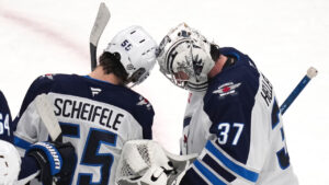 Winnipeg Jets centre Mark Scheifele (55) congratulates goaltender Connor Hellebuyck (37) after they defeated the Boston Bruins in an NHL hockey game, Thursday, Jan. 30, 2025, in Boston. (Charles Krupa/AP)