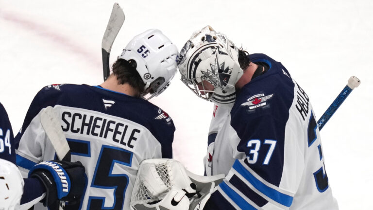 Winnipeg Jets centre Mark Scheifele (55) congratulates goaltender Connor Hellebuyck (37) after they defeated the Boston Bruins in an NHL hockey game, Thursday, Jan. 30, 2025, in Boston. (Charles Krupa/AP)