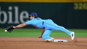 Toronto Blue Jays second baseman Josh Smith is unable to trap a throw from teammate shortstop Andrés Giménez on a fielder's choice ball hit by Texas Rangers' Danny Jansen during the second inning of a baseball game Saturday, Sept. 19, 2026, in Arlington, Texas. (Julio Cortez/AP)