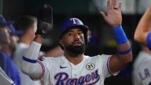 Texas Rangers' Ezequiel Duran is greeted in the dugout after scoring on a double by teammate Elias Diaz against the Boston Red Sox during the second inning of a baseball game Tuesday, Sept. 15, 2026, in Arlington, Texas. (Julio Cortez/AP)