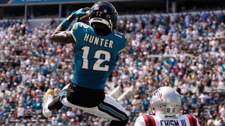 Jacksonville Jaguars wide receiver Travis Hunter (12) intercepts a pass against New England Patriots wide receiver Efton Chism III (86) in the first half during an NFL football game in Jacksonville, Fla., Sunday, Sept. 27, 2026. (Mike Stewart/AP)