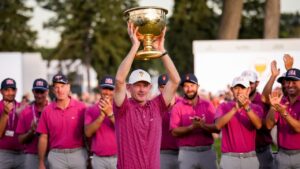 USA team captain Brandt Snedeker holds the Presidents Cup trophy as his team look on after their win over the International team in the Presidents Cup golf tournament final round at Medinah Country Club, Sunday, Sept. 27, 2026, in Medinah, Ill. (Matt Slocum/AP)