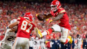 Kansas City Chiefs running back Kenneth Walker III (9) leaps into the end zone for a touchdown against the Denver Broncos during the second half of an NFL football game in Kansas City, Mo., Monday, Sept. 14, 2026. (AP Photo/Reed Hoffmann)