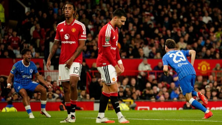 Brighton's Maxim De Cuyper, right, celebrates after scoring his side's third goal during the English League Cup third round soccer match between Manchester United and Brighton and Hove Albion in Manchester, England, Wednesday, Sept. 16, 2026. (AP Photo/Dave Thompson)