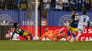 CF Montreal's Prince Owusu (9) scores on Vancouver Whitecaps goalkeeper Isaac Boehmer (second left) during first half MLS soccer action in Montreal on Wednesday, Sept. 16, 2026. THE CANADIAN PRESS/Peter McCabe