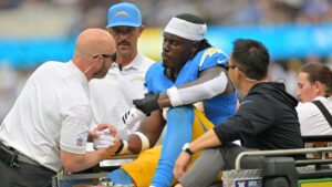 Los Angeles Chargers tight end David Njoku (83) is carted off the field after an injury during the first half of an NFL football game against the Las Vegas Raiders in Inglewood, Calif., Sunday, Sept. 20, 2026. (AP Photo/Jayne Kamin-Oncea)