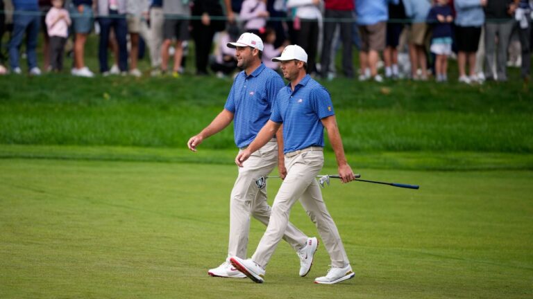 USA teams' Scottie Scheffler and Sam Burns, right, walk up the first fairway during the first round four-ball match at the Presidents Cup golf tournament against the International team at Medinah Country Club, Thursday, Sept. 24, 2026, in Medinah, Ill. (AP Photo/Matt Slocum)