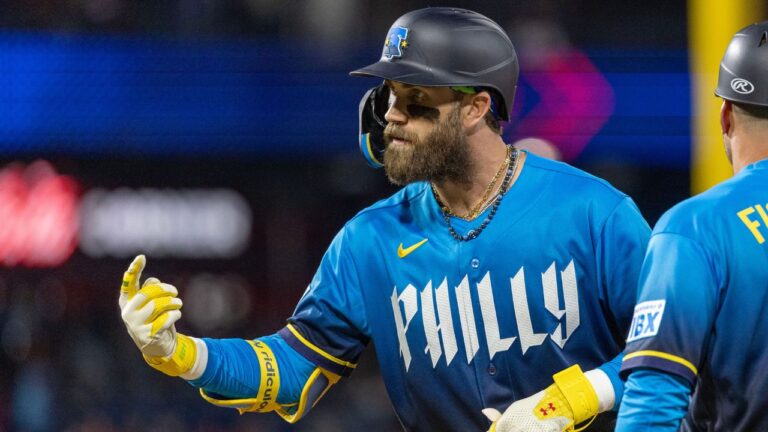 Philadelphia Phillies' Bryce Harper gestures from first base after hitting a single during the sixth inning of a baseball game against the Tampa Bay Rays, Friday, Sept. 25, 2026, in Philadelphia. (AP Photo/Laurence Kesterson)