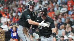 Chicago White Sox's Kyle Teel, left, and Miguel Varga, right, celebrate after scoring during the first inning in Game 2 of baseball's American League Wild Card Series against the Houston Astros, Wednesday, Sept. 30, 2026, in Houston. (AP Photo/Karen Warren)