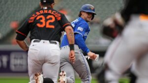 Toronto Blue Jays' Ernie Clement, right, attempts to avoid the tag of Baltimore Orioles third baseman Christian Encarnacion-Strand during the third inning in the first game of a doubleheader, Wednesday, Sept. 23, 2026, in Baltimore. (Stephanie Scarbrough/AP)