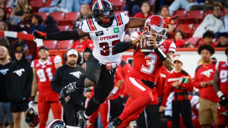 Ottawa Redblacks' Kyahva Tezino, top left, chases Calgary Stampeders quarterback Vernon Adams Jr. during second half CFL football action in Calgary, Saturday, Sept. 19, 2026. (Jeff McIntosh/CP)
