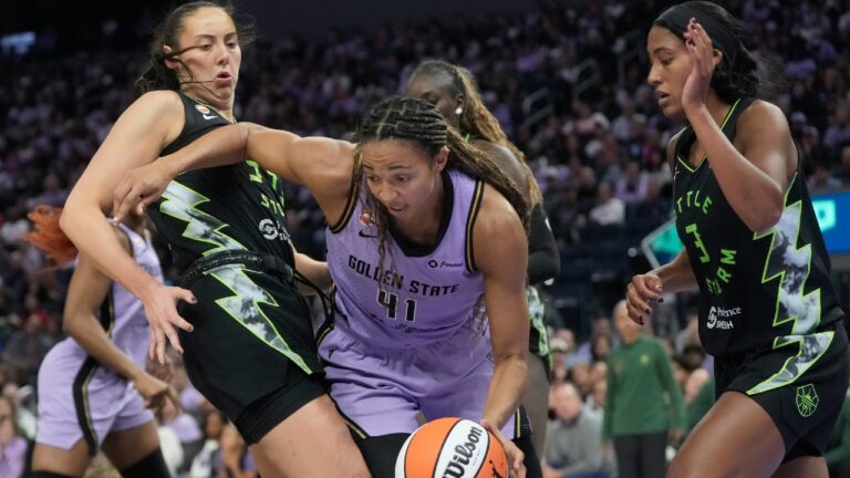 Golden State Valkyries center Kiah Stokes (41) drives to the basket against Seattle Storm forward Mackenzie Holmes, left, and guard-forward Taylor Thierry (3) during the second half of a WNBA basketball game in San Francisco, Saturday, Sept. 19, 2026. (AP Photo/Jeff Chiu)