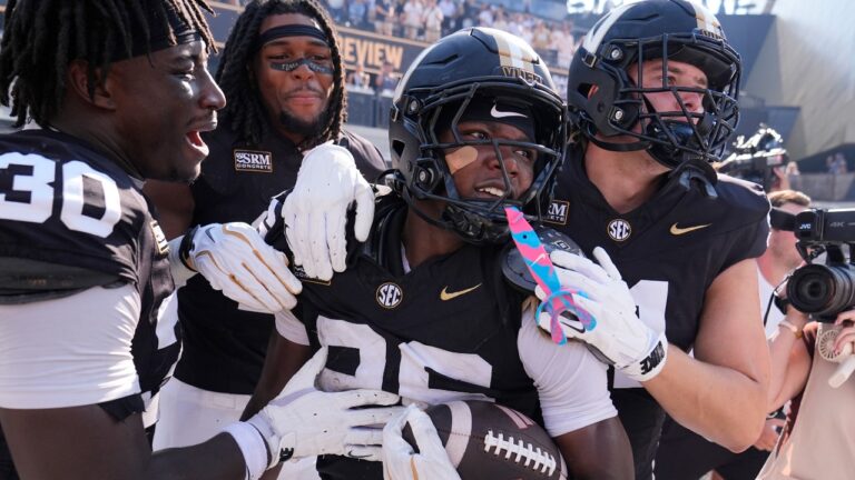 Vanderbilt cornerback Cayden Daniels, second from right, celebrates his touchdown with teammates during the second half of an NCAA college football game against North Carolina State, Saturday, Sept. 19, 2026, in Nashville, Tenn. (AP Photo/George Walker IV)
