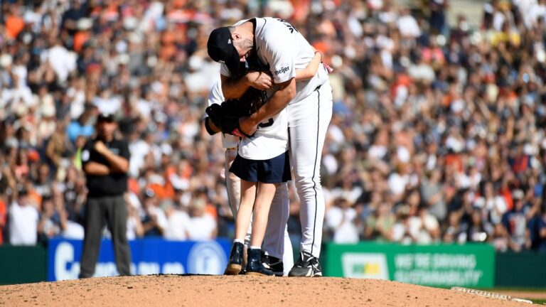 Genevieve Verlander, left, hugs her dad, Detroit Tigers starting pitcher Justin Verlander, during the sixth inning of a baseball game against the Pittsburgh Pirates, Saturday, Sept. 26, 2026, in Detroit. (AP Photo/Jose Juarez)