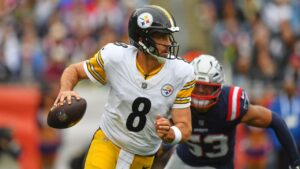 Pittsburgh Steelers' Aaron Rodgers (8) looks to pass as New England Patriots' Christian Elliss (53) pressures him during the first half of an NFL football game, Sunday, Sept. 20, 2026, in Foxboro, Mass. (Steven Senne/AP)