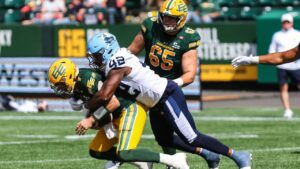 Edmonton Elks' quarterback Cody Fajardo (7) is sacked by Toronto Argonauts' Shawn Lemon (42) during second half CFL football action in Edmonton on Saturday, Aug. 15, 2026. (Codie McLachlan/THE CANADIAN PRESS)