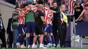 Atletico Madrid's head coach Diego Simeone, right, celebrates with the players after Atletico Madrid's Jonathan David scored their side's second goal during a Spanish La Liga soccer match between Atletico Madrid and Real Madrid. (Bernat Armangue/AP)