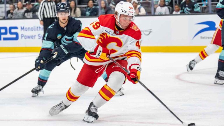 Calgary Flames forward Andrew Basha, right, skates against Seattle Kraken forward Mackie Samoskevich during the third period of a preseason NHL hockey game. (Stephen Brashear/AP)