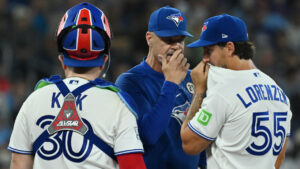 Toronto Blue Jays pitching coach Pete Walker visits pitcher Michael Lorenzen (55) and catcher Alejandro Kirk (30) on the mound during fourth inning MLB baseball action against the Detroit Tigers in Toronto on Tuesday, Sept. 15, 2026. (Jon Blacker/CP)