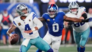Dallas Cowboys quarterback Dak Prescott (4) looks to pass as New York Giants linebacker Brian Burns (0) gets by the block of Cowboys' TJ Bass (66) during the first half of an NFL football game Sunday, Sept. 13, 2026, in East Rutherford, N.J. (Yuki Iwamura/AP)