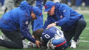 New York Giants linebacker Brian Burns (0) is assisted by the team's medical staff after being injured during the second half of an NFL football game. (Frank Franklin II/AP)