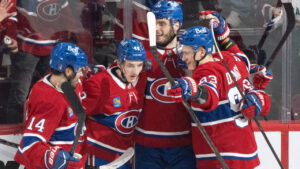 Montreal Canadiens' Lane Hutson (48) celebrates his goal with teammates Nick Suzuki (14), Juraj Slafkovsky (20) and Ivan Demidov (93) during second period of Game 3 of the NHL Eastern Conference final Stanley Cup playoff series against the Carolina Hurricanes, in Montreal on Monday, May 25, 2026. (Christinne Muschi/CP)