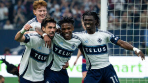 Vancouver Whitecaps' Brian White, left, celebrates his goal against FC Dallas with Edier Ocampo (18), Emmanuel Sabbi (11) and Oliver Larraz, back, during the first half of an MLS soccer match in Vancouver, on Saturday, August 22, 2026. (Ethan Cairns/CP)