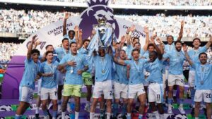 Manchester City players celebrate with the Premier League trophy after the English Premier League soccer match between Manchester City and West Ham United in Manchester, England, Sunday, May 19, 2024. (Dave Thompson/AP)
