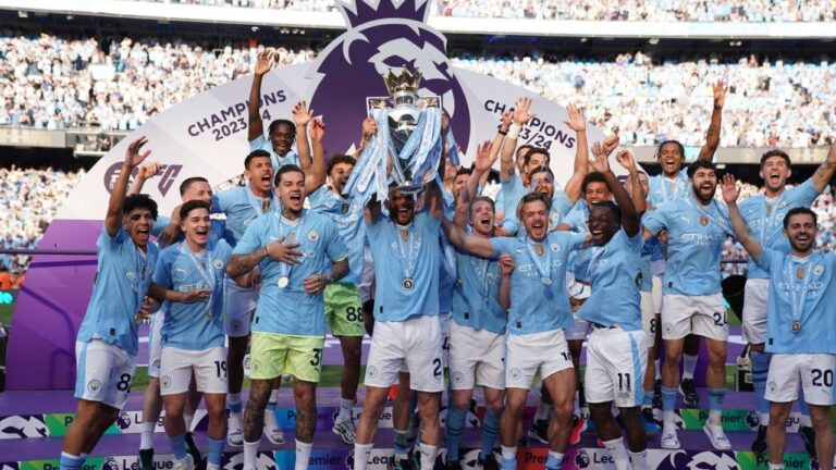 Manchester City players celebrate with the Premier League trophy after the English Premier League soccer match between Manchester City and West Ham United in Manchester, England, Sunday, May 19, 2024. (Dave Thompson/AP)